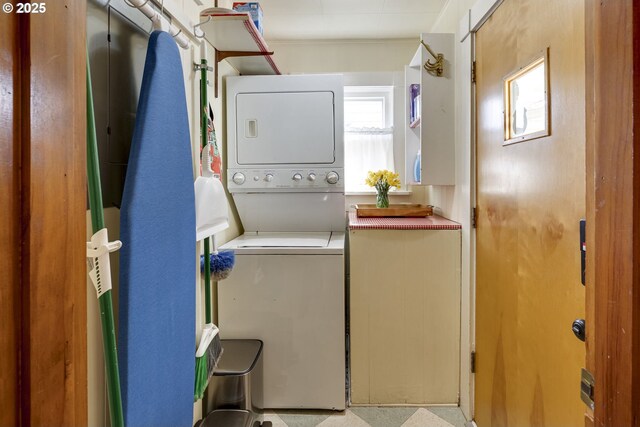 washroom featuring stacked washer / dryer