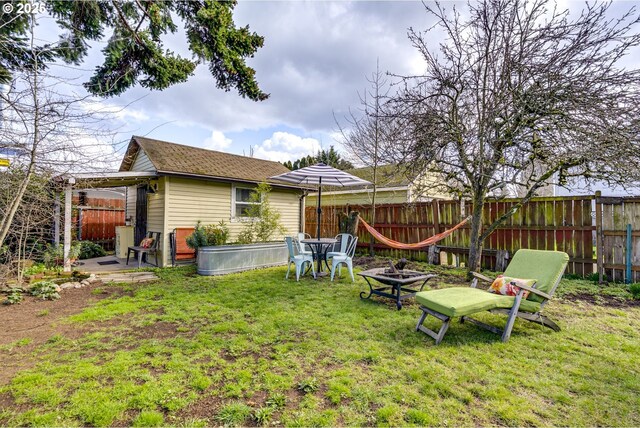 view of yard with a fire pit and fence