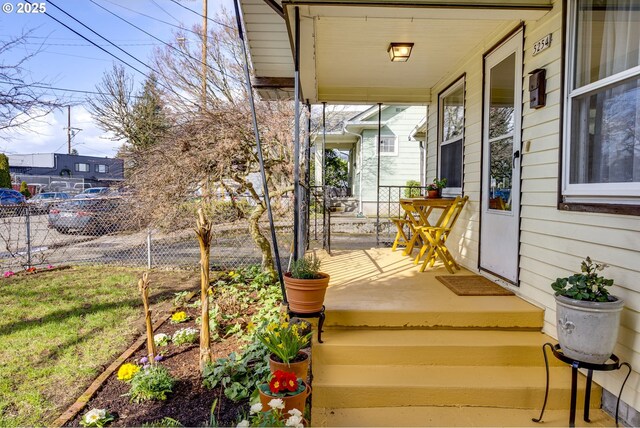 deck with a porch and fence