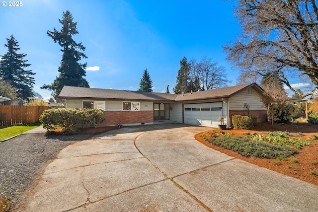 ranch-style home featuring driveway, brick siding, an attached garage, and fence