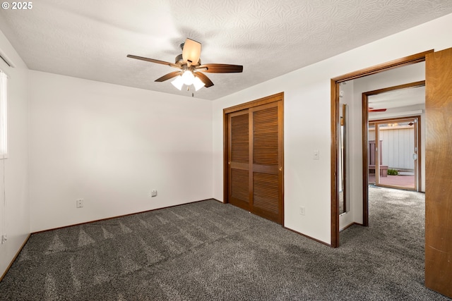 unfurnished bedroom with a ceiling fan, a closet, carpet flooring, and a textured ceiling