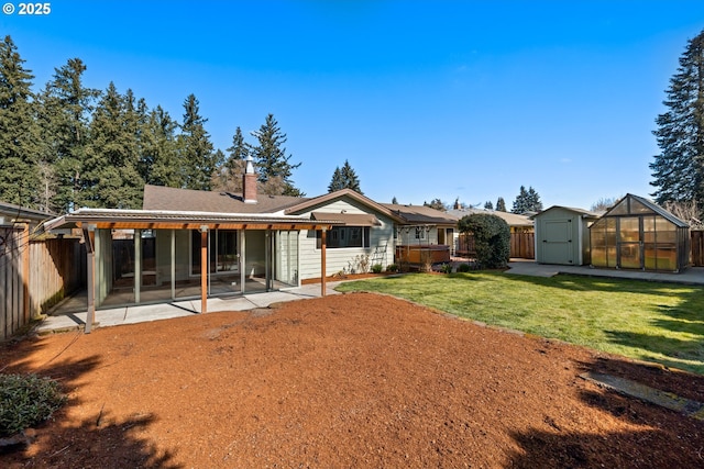 back of house with a patio area, a fenced backyard, a storage unit, and an outdoor structure