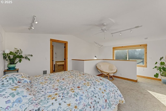 carpeted bedroom with vaulted ceiling, rail lighting, a textured ceiling, and ceiling fan