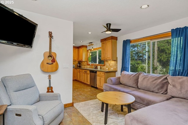 tiled living room featuring sink and ceiling fan