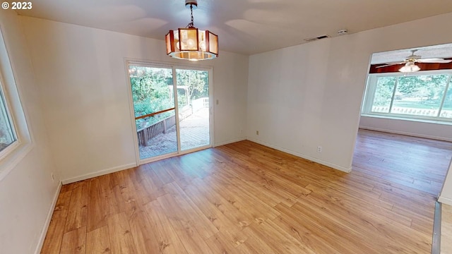 spare room with light wood-type flooring and ceiling fan