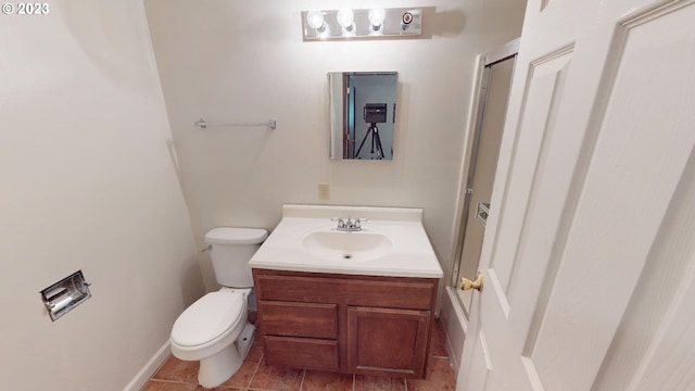 bathroom with tile patterned floors, vanity, and toilet