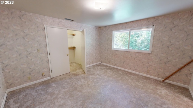 unfurnished room featuring light colored carpet