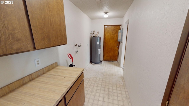 interior space featuring water heater and a textured ceiling