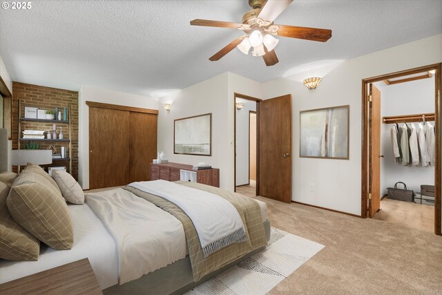 1200 NE Territorial Rd Unit 73, Canby, OR 97013 - bedroom featuring light colored carpet, a textured ceiling, baseboards, ceiling fan, and a closet
