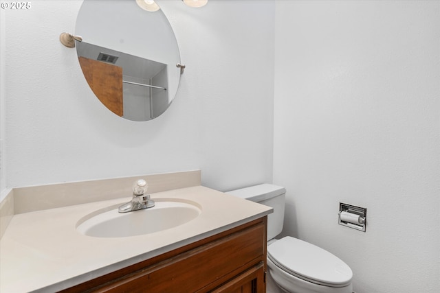 bathroom with toilet and vanity