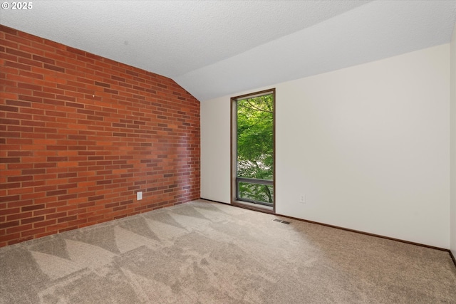 1200 NE Territorial Rd Unit 73, Canby, OR 97013 - unfurnished room with carpet floors, vaulted ceiling, brick wall, and baseboards