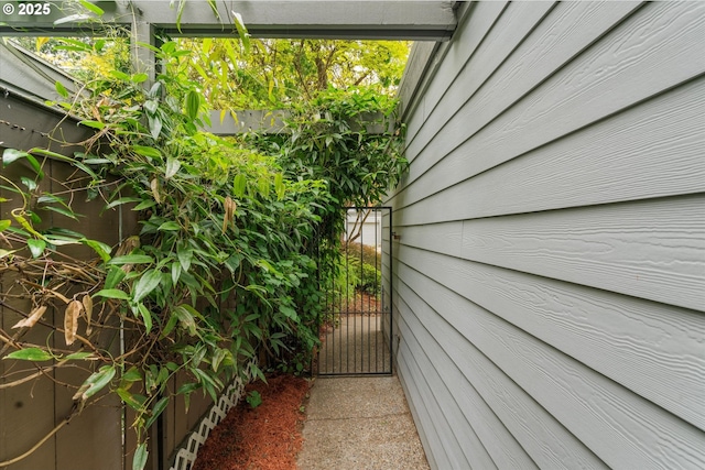 view of side of home with a gate