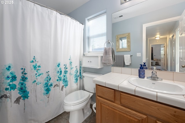 full bath with visible vents, toilet, vanity, a shower with curtain, and tile patterned floors