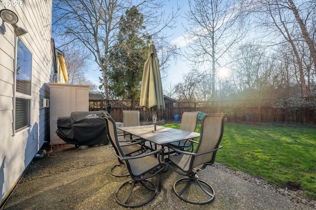 view of patio featuring outdoor dining area, grilling area, and a fenced backyard