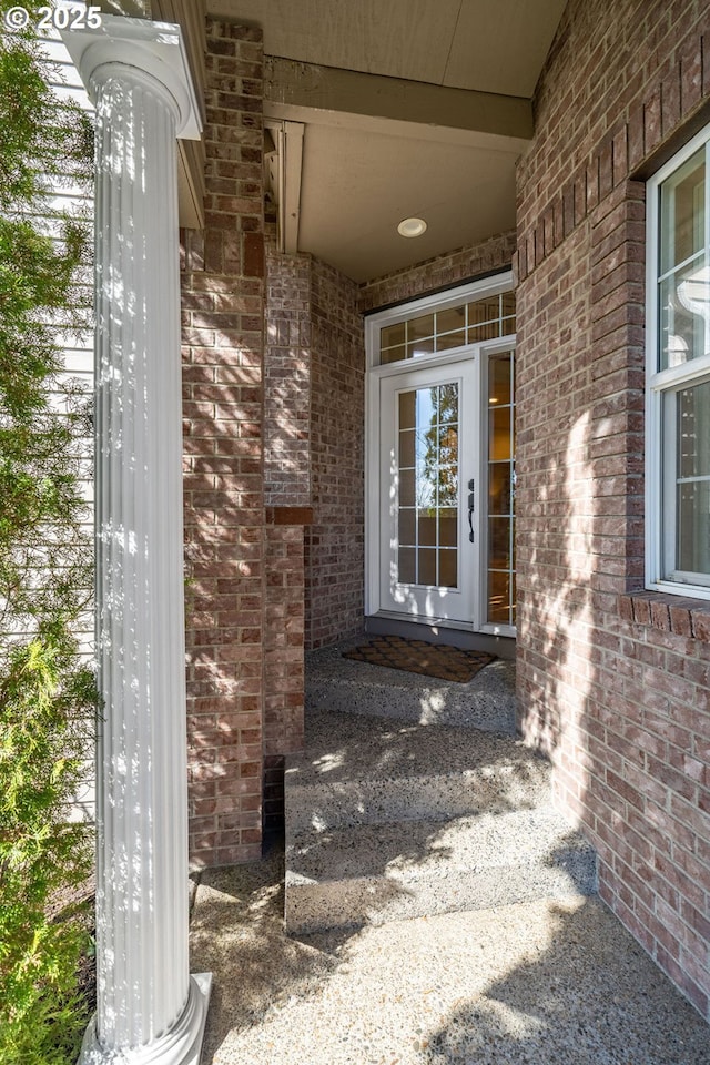 doorway to property with brick siding