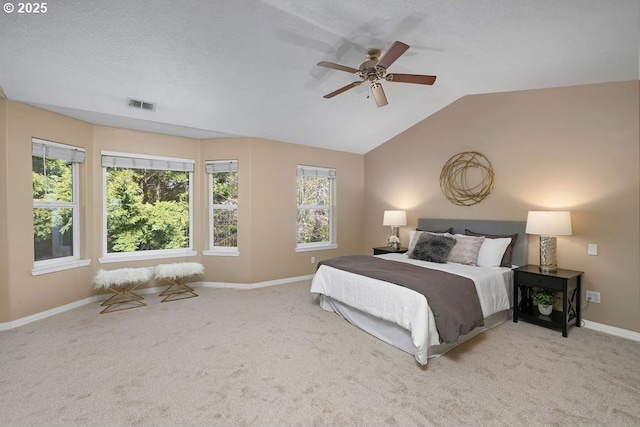 bedroom with ceiling fan, carpet flooring, visible vents, baseboards, and vaulted ceiling