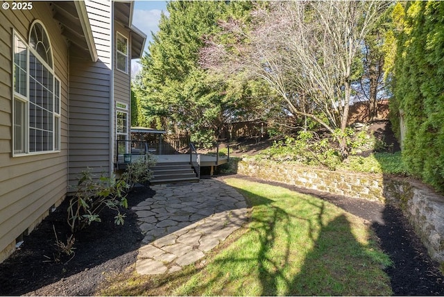 view of yard featuring a deck and a patio