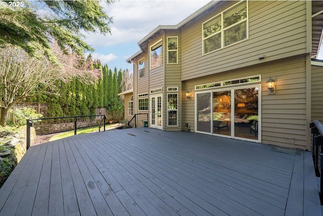 wooden terrace featuring fence and french doors