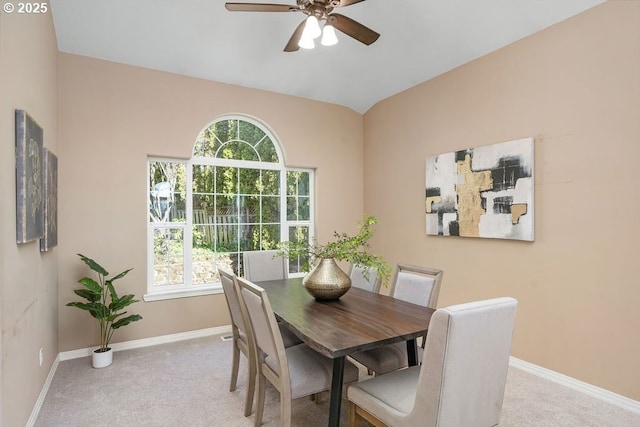 dining space with carpet floors, lofted ceiling, ceiling fan, and baseboards