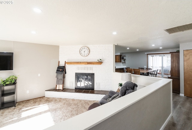 living room featuring dark wood-type flooring and a brick fireplace