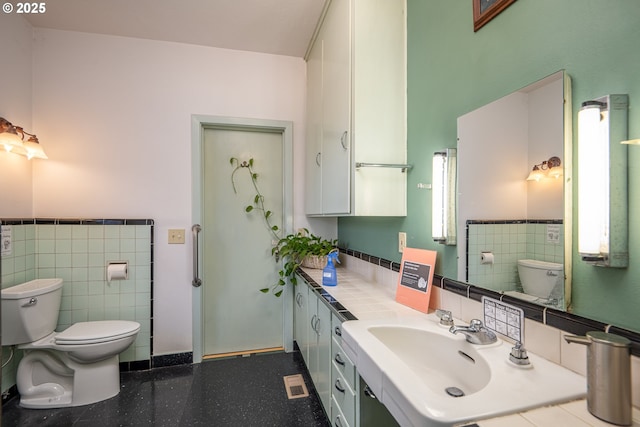 1034 Lawrence St, Eugene, OR 97401 - bathroom with tile walls, vanity, and a wainscoted wall