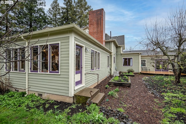 1034 Lawrence St, Eugene, OR 97401 - view of side of property with a wooden deck and a garden
