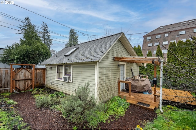 1034 Lawrence St, Eugene, OR 97401 - view of property exterior with a deck, a gate, an outdoor structure, and cooling unit