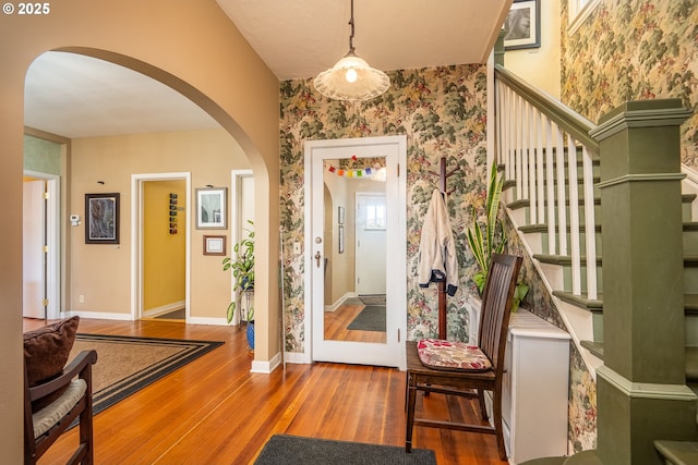 1034 Lawrence St, Eugene, OR 97401 - foyer entrance with wallpapered walls, arched walkways, wood-type flooring, and stairway