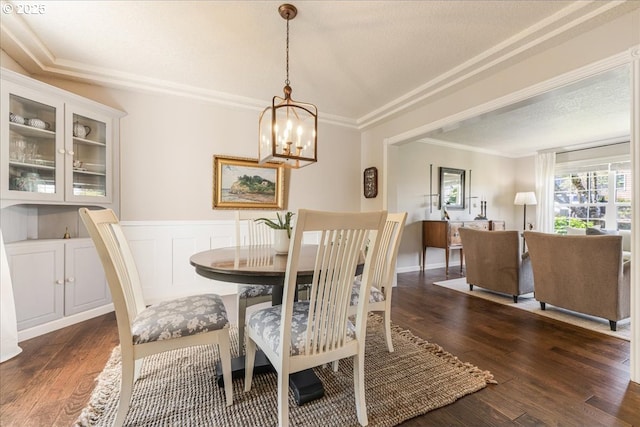 14940 SW Michael Ct, Sherwood, OR 97140 - dining space featuring ornamental molding, dark wood-style floors, and a chandelier