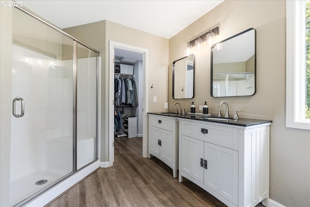 14940 SW Michael Ct, Sherwood, OR 97140 - bathroom with wood finished floors, double vanity, a stall shower, and baseboards