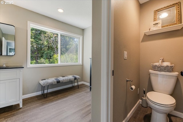 14940 SW Michael Ct, Sherwood, OR 97140 - bathroom featuring vanity, wood finished floors, toilet, and baseboards