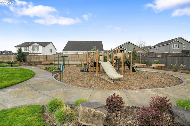 view of playground featuring fence and a residential view
