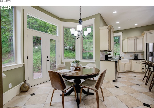 dining room with light tile patterned floors, recessed lighting, a notable chandelier, and french doors