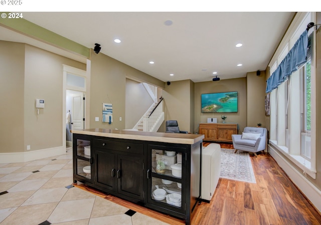 interior space featuring light wood-style floors, stairs, baseboards, and recessed lighting