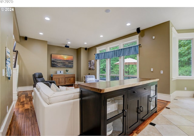 living room with plenty of natural light, baseboards, and recessed lighting