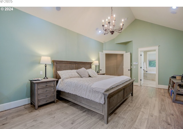 bedroom with a chandelier, high vaulted ceiling, baseboards, light wood-style floors, and ensuite bath