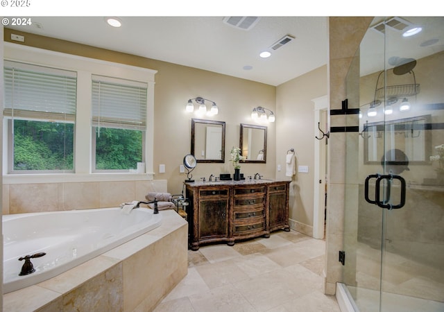 full bath featuring double vanity, a garden tub, a shower stall, and visible vents