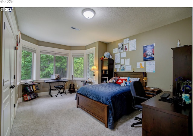 bedroom with baseboards, carpet, visible vents, and a textured ceiling