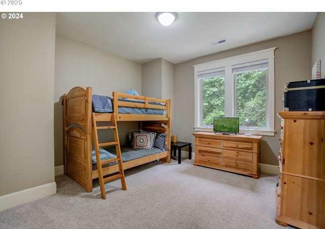 bedroom featuring carpet floors, visible vents, and baseboards