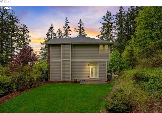 back of house with a patio area and a yard