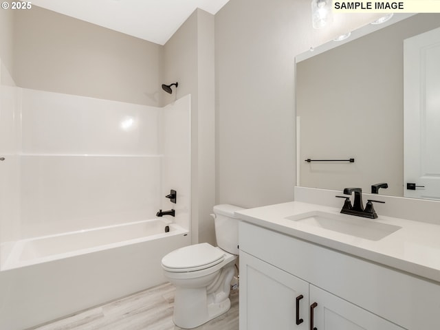 bathroom with toilet, shower / washtub combination, wood finished floors, and vanity