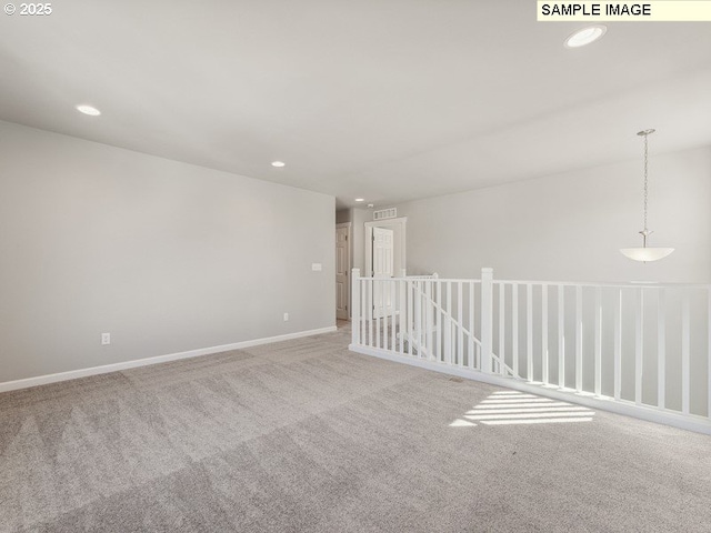 carpeted empty room featuring visible vents, recessed lighting, and baseboards