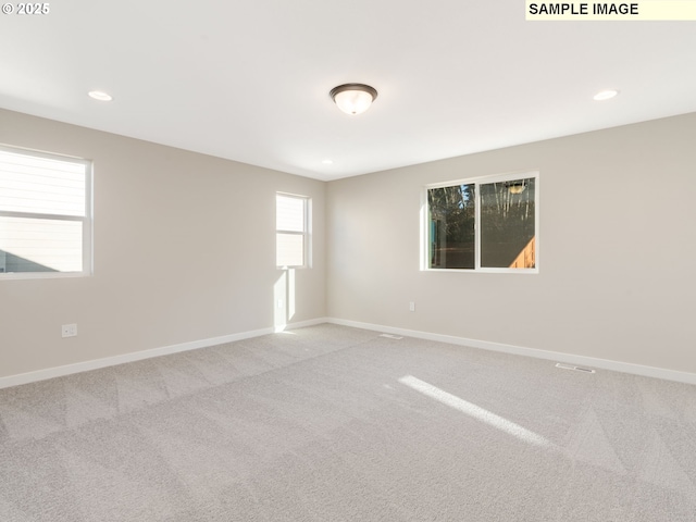 carpeted spare room with recessed lighting and baseboards