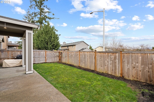 view of yard featuring a patio area and a fenced backyard