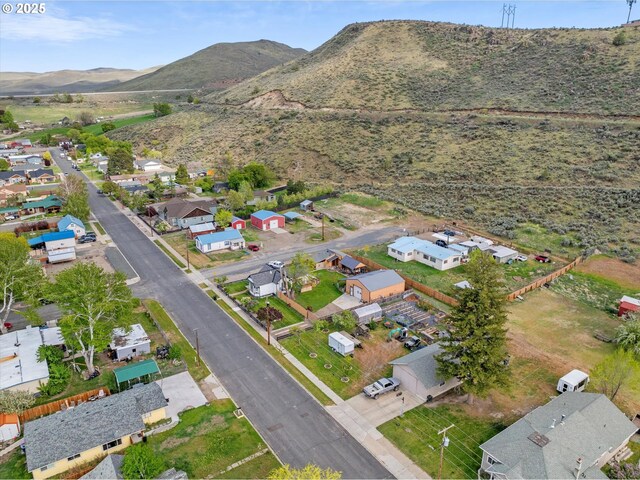 aerial overview of property's location with a mountain backdrop and nearby suburban area