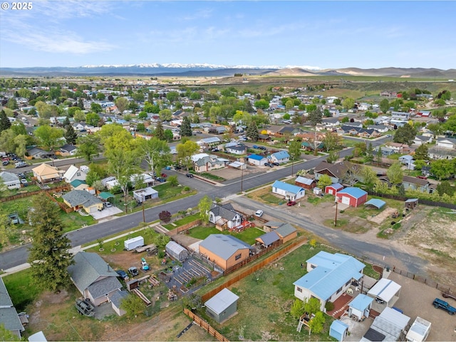 aerial view of property and surrounding area with a mountain backdrop and nearby suburban area