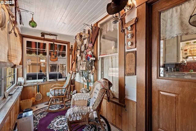living area featuring wood walls and wood ceiling