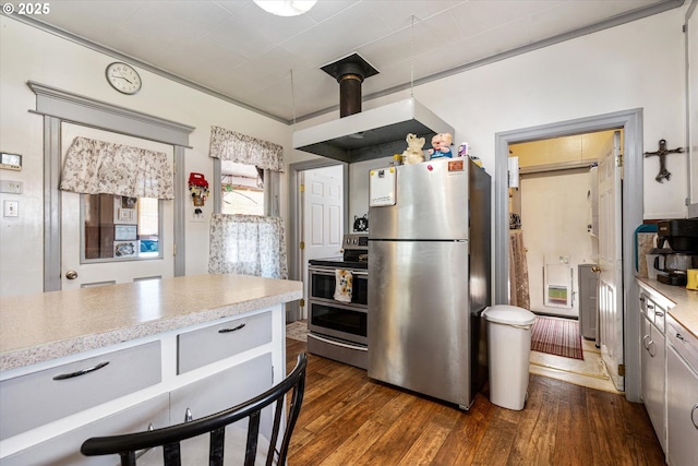 kitchen with appliances with stainless steel finishes, light countertops, and dark wood finished floors