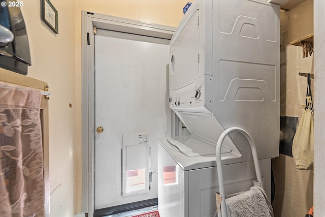 laundry area with stacked washing machine and dryer