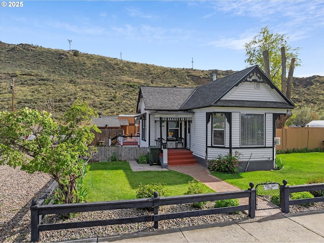 view of front of house featuring a mountain view and a gate